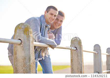 Couple, portrait and happy gay male people, smile and marriage in nature at park. LGBT, love and support or trust from partner in relationship, queer and summer on holiday or honeymoon for relax 114328211