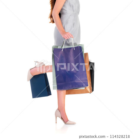 Woman, legs and shopping bags for fashion in studio on white background for sale, discount and spend. Boxes, female person and excited as customer with retail prices, bargain and gifts or present 114328218