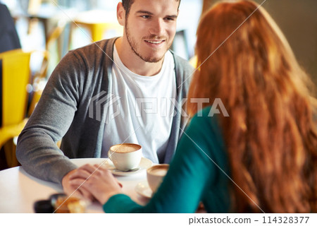 Couple, man and smile for touch in coffee shop, love and support with happiness for peace in marriage. Adult, male person and together with girl or partner holding hands in cafe, joy and relax 114328377