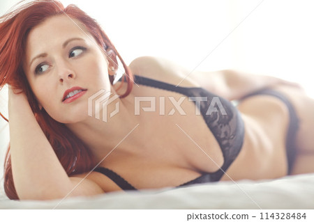 Lingerie, thinking and fashion of woman on bed with seductive, clothes and sexy style at home. Sensual, confidence and female person with pride in underwear for alluring outfit, idea and temptation 114328484