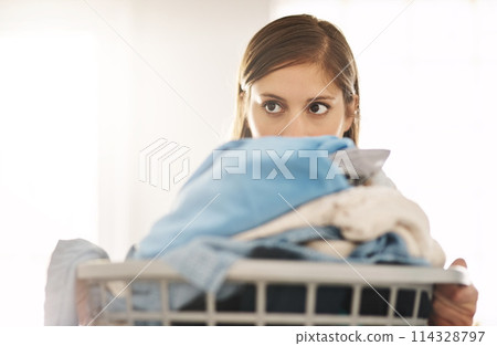 Thinking, woman and cleaning laundry in home and planning to tidy basket with dirty clothes, Girl, washing and cleaner start task in apartment with container of linen, fabric and maid with ideas 114328797