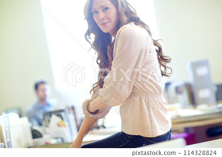 Portrait, creative and business woman in office at workplace for career or job in Ireland. Professional, designer and employee, entrepreneur or female person coworking in startup company on desk Portrait, creative and business woman in office at workplace for career or job in Ireland. Professional, designer and employee, entrepreneur or female person coworking in startup company on desk 114328824