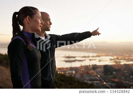 Exercise, nature and couple with hand pointing to sunset, city view or fitness vision. Health, training and sports people outside planning running route, workout or speed target together at sunrise 114328842