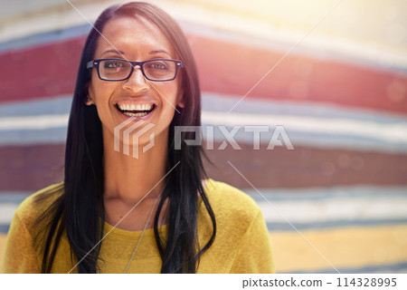 Woman, portrait and smile for eyewear outdoors, cool frame and proud of lens by wall background. Female person, prescription and designer glasses or style, optical health and happy or confidence 114328995