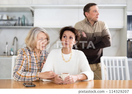 Family quarrel, old woman calming woman Family quarrel, old woman calming woman 114329207
