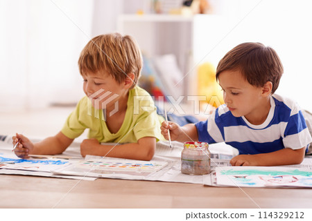 Young children, painting and creative with paint brush on floor or playing room, hobby and drawing together at home. Brothers, motor skills and growth for childhood development with smile for artwork 114329212