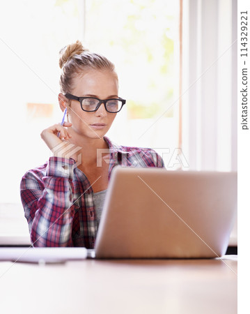 Reading, designer and woman with remote work, laptop or glasses in home office for creative ideas. Website, documents review or freelancer in a startup, business or house with online report or news 114329221