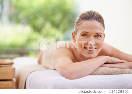Happy woman, portrait and relax with massage for spa, zen or relaxation at hotel or outdoor resort. Face of female person with smile, enjoying facial or body treatment at accommodation for wellness 114329291