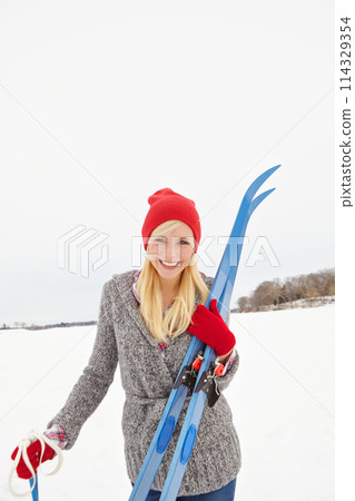 Woman, ski and snow with portrait on holiday for fitness, adventure and outdoor in mountains with smile. Person, happy and equipment for winter sports in nature for vacation getaway in Switzerland 114329354