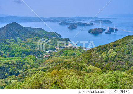Looking west towards the Kurushima Kaikyo Bridge from the observation deck of Kirosan Observation Park in Imabari City, Ehime Prefecture in spring 114329475
