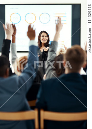 Businesswoman, presentation and hands up in audience for conference with graphs, review or questions. Female person, trade show and back in meeting convention for mentorship, statistics or percentage 114329518