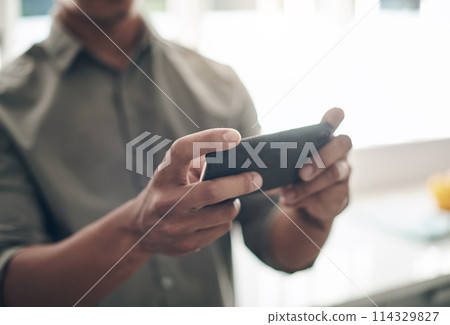 Phone, search and hands of man in house with gaming, competition or online contest closeup. Smartphone, app and male person streaming social media, video or movie, film or show, web or communication Phone, search and hands of man in house with gaming, competition or online contest closeup. Smartphone, app and male person streaming social media, video or movie, film or show, web or communication 114329827