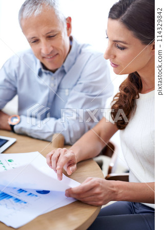 Meeting, man and woman in office with documents for sales review, growth or development online. Planning, strategy and business people at desk with stats for data analysis, feedback or profit report 114329842