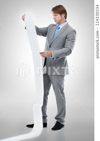 Businessman, documents and receipt with finance for bills, expenses or list on a gray studio background. Man or employee checking financial paperwork or report for audit or budget planning on mockup 114330334