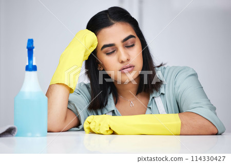Woman, sleeping and tired cleaner with spray bottle for table, kitchen counter or dirty furniture in home. Burnout, exhausted maid and lazy Indian janitor on break with product, liquid soap or gloves 114330427