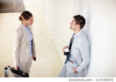 Businessman, businesswoman and conversation with coffee, office and briefcase in workplace. Businesspeople, employees and company in business, sector and corporate for collaboration or discussion 114330676