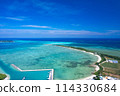 [Okinawa, Miyakojima] Drone shot of Ikema Island, Ikema Bridge, and the blue sea from above Karimata Fishing Port② 114330684