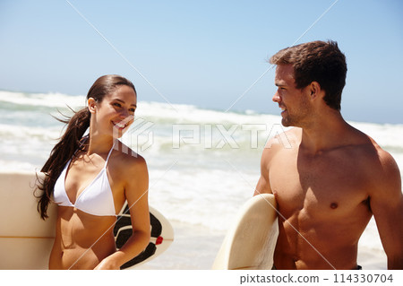 Couple, beach and surfboard for surfing or water with happiness, adventure and fitness with blue sky. Man, woman and surfer by ocean in the morning for holiday, vacation and freedom with swimwear Couple, beach and surfboard for surfing or water with happiness, adventure and fitness with blue sky. Man, woman and surfer by ocean in the morning for holiday, vacation and freedom with swimwear 114330704