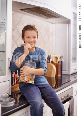 Portrait, smile and cookie jar with boy child in kitchen of home, eating biscuits on counter in morning. Breakfast, food and relax with happy young kid in apartment for hunger, snack or treats Portrait, smile and cookie jar with boy child in kitchen of home, eating biscuits on counter in morning. Breakfast, food and relax with happy young kid in apartment for hunger, snack or treats 114330738