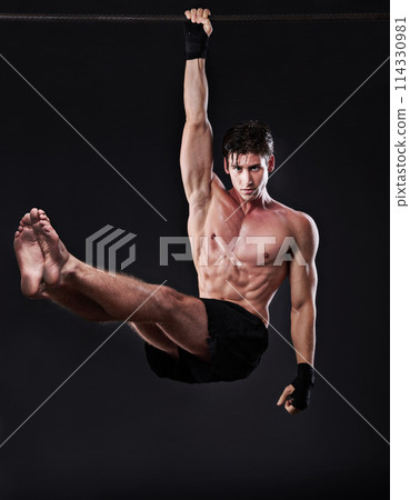 Man, fitness, and training bar in portrait for sport, workout and bodybuilding on black studio backdrop. Energy, pull up and muscle with male model for exercise hang and mma competition motivation 114330981