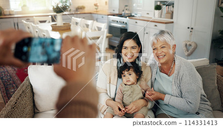 Phone screen, hands and picture of family in living room with smile, kids and grandparent on sofa. Social media, photo and mother with a baby and grandmother happy in a home together with love 114331413