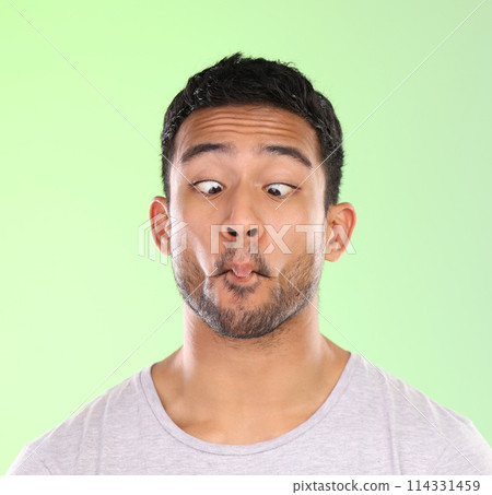 Man, play and silly in studio, face and goofy comic or funny expression on green background. Male person, mockup space and guy for joke or comedy, student and humor for crazy character and quirky Man, play and silly in studio, face and goofy comic or funny expression on green background. Male person, mockup space and guy for joke or comedy, student and humor for crazy character and quirky 114331459