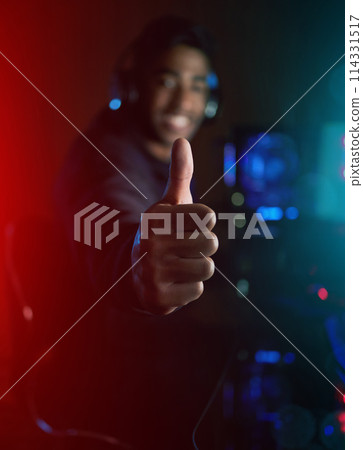 Gamer, man and thumbs up with hand in home, dark and happy for streaming, challenge and contest on web. Person, sign and symbol for like, yes and agreement for pro gaming, esports and competition 114331517
