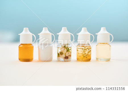 Healthcare, herbal medicine and bottle on table for alternative wellness or natural organic remedy. Container, medical and oil to cure, heal or treat as pharmaceutical product for chronic illness 114331556