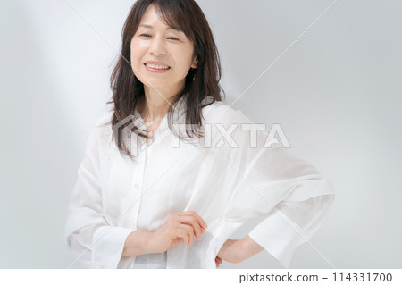 Portrait of a middle-aged woman in a white shirt Portrait of a middle-aged woman in a white shirt 114331700