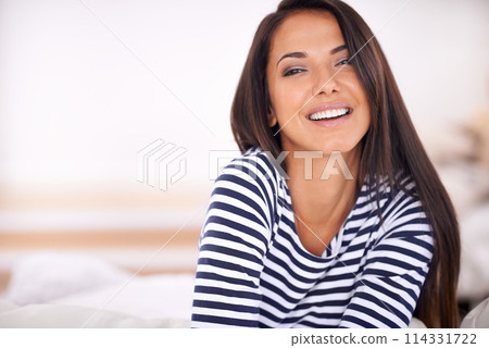 Woman, portrait and relax in bed on weekend, smile and satisfaction in home for enjoyment. Happy female person, morning and confident on mockup space, wake up and wellness by peace or calm in bedroom 114331722