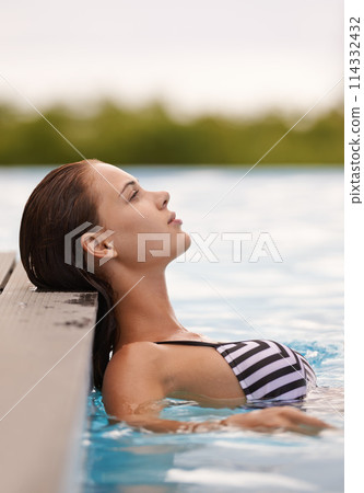 Woman, thinking and relax in swimming pool on luxury holiday or vacation at hotel or villa in Cancun. Person, outdoor or enjoy calm water at resort in Mexico or girl in bikini or swimsuit with peace Woman, thinking and relax in swimming pool on luxury holiday or vacation at hotel or villa in Cancun. Person, outdoor or enjoy calm water at resort in Mexico or girl in bikini or swimsuit with peace 114332432