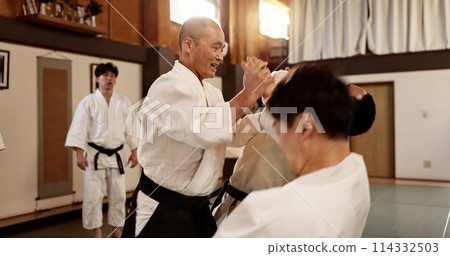 Aikido class, man and sensei for martial arts, learning and advice for combat at training, gym and dojo. Japanese people, master and sports with fight, workout and fitness for zen, conflict or club 114332503