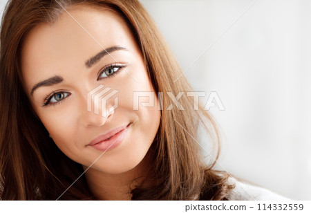 Face, young woman and relax with smile at home, happy and healthy with positive mood, pride and calm. Peace, confidence and student on break with gen z and chilling in apartment in a portrait 114332559