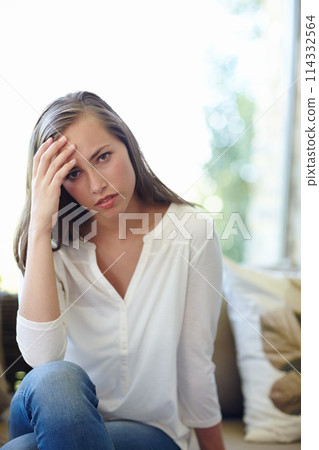 Woman, home and portrait with anxiety on sofa for stress, worried or concern or tension. Female person, house and headache with hand for trouble or fear, unhappy or miserable or mental health 114332564