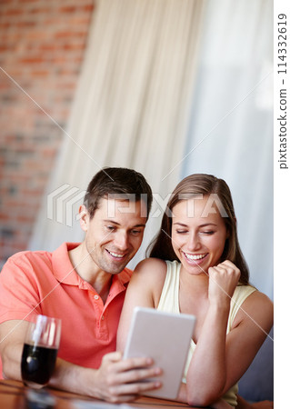 Couple, relax and smile in home with tablet for streaming online for movies or films, videos and social media memes. Man, woman and together with hug for bonding or love with affection and support. 114332619