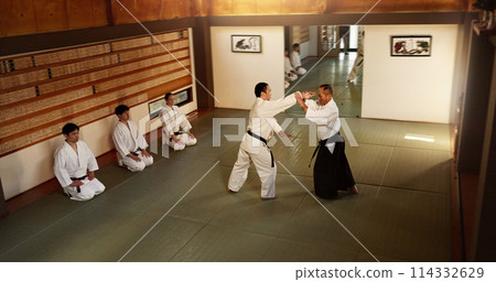 Japanese men, martial arts class or training in fight, modern or aikido to learn self defence. Sensei, black belt students and instruction in dojo place, sport and combat demonstration for discipline Japanese men, martial arts class or training in fight, modern or aikido to learn self defence. Sensei, black belt students and instruction in dojo place, sport and combat demonstration for discipline 114332629