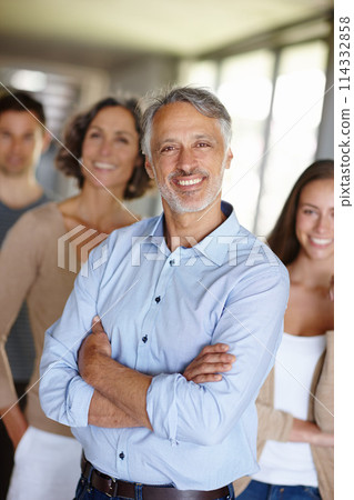 Teamwork, portrait and senior businessman in office, leader or CEO in workplace with team. Face, smile and manager with management at design business firm, collaboration and professional company 114332858