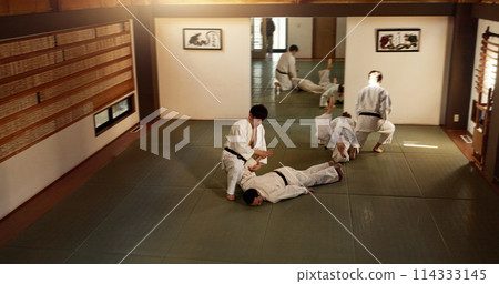 Japanese men, training and aikido fighting, modern martial arts and learning self defence. Respect, black belt students and instruction in dojo place and combat demonstration for discipline in class Japanese men, training and aikido fighting, modern martial arts and learning self defence. Respect, black belt students and instruction in dojo place and combat demonstration for discipline in class 114333145
