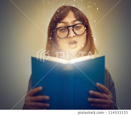 Glowing pages, book and woman with a story, reading and education on grey studio background. Person, model and girl with a novel and literature with knowledge and creativity with fantasy or astrology Glowing pages, book and woman with a story, reading and education on grey studio background. Person, model and girl with a novel and literature with knowledge and creativity with fantasy or astrology 114333155
