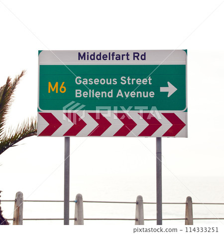 Road sign, intersection and direction in city with arrow for grammar, mistake or text for gas for driving in neighborhood. Buildings, error and funny signage with joke, fart and warning in Cape Town 114333251