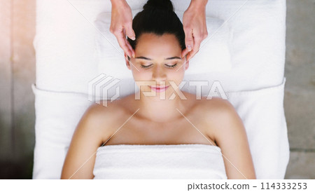 Spa, salon and woman relax for head massage, facial treatment and luxury pamper. Aesthetic, skincare and above of person with eyes closed at resort for wellness, cosmetic service or beauty therapy 114333253