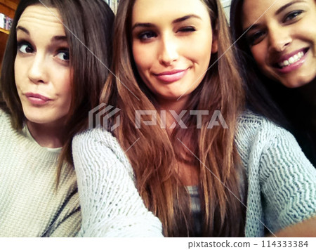 Student, selfie and girls with friends funny, happy and fun for social media upload post with group. University, college and educational leaners in library, carefree together for study session break Student, selfie and girls with friends funny, happy and fun for social media upload post with group. University, college and educational leaners in library, carefree together for study session break 114333384