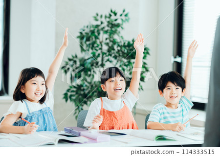 Elementary school students studying at a cram school. Elementary school students studying at a cram school. 114333515