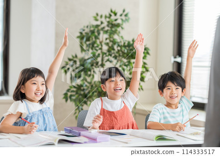 Elementary school students studying at a cram school. Elementary school students studying at a cram school. 114333517