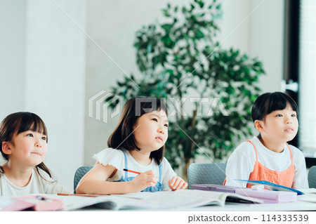 Elementary school students studying at a cram school. Elementary school students studying at a cram school. 114333539