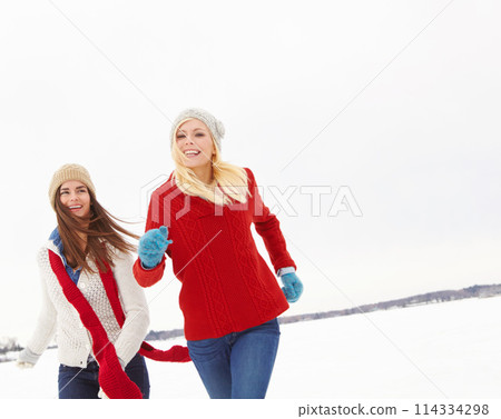 Winter, happy and friends with travel in snow for adventure, weekend trip and holiday in Switzerland. Smile, women and adventure with bonding in cold weather for vacation, journey or tourism together 114334298