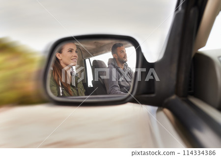 Couple, car and mirror on roadtrip with travel for adventure, vacation and reflection with happiness in countryside. Woman, man and driving in transport for holiday journey, tourism or honeymoon trip 114334386