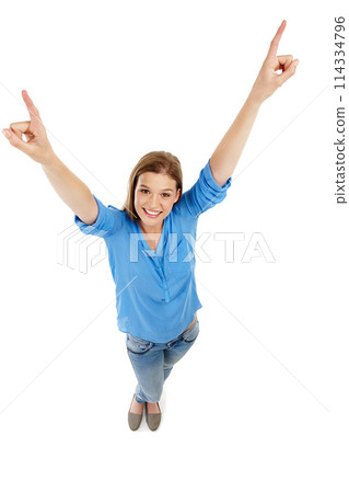Pointing up, girl and smile in studio for portrait, cheer and excitement on white background. Young woman, happy and arms raised for positivity in high angle, yes and supportive for good energy 114334796