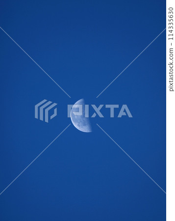A white moon floating in the blue sky A white moon floating in the blue sky 114335630