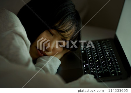 Young woman spending her time in bed Young woman spending her time in bed 114335695